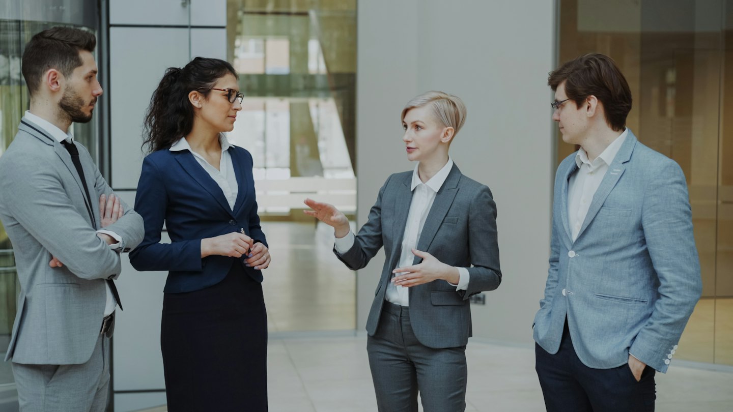 Diverse professionals collaborating in a modern office setting.